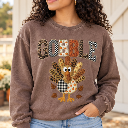 Gobble Patchwork Turkey Thanksgiving Tee — artwork preview on sweatshirt; product sold as short-sleeve tee