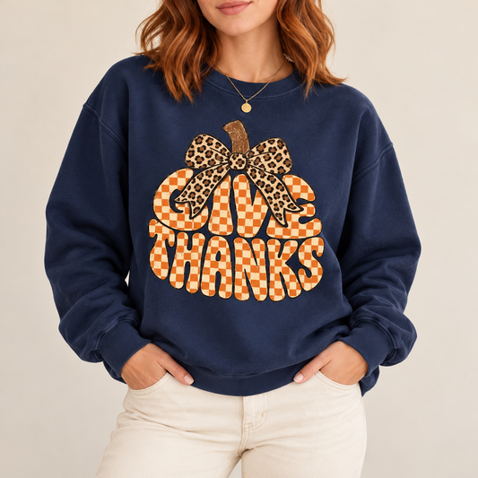 Give Thanks Checkerboard Pumpkin Bow Tee — artwork preview on sweatshirt; product sold as short-sleeve tee